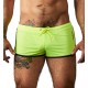 Sporty shorts with rounded hems in a contrasting colour and a drawstring in the waistband. Neon yellow/black. 75% polyamide, 25% elastane.
